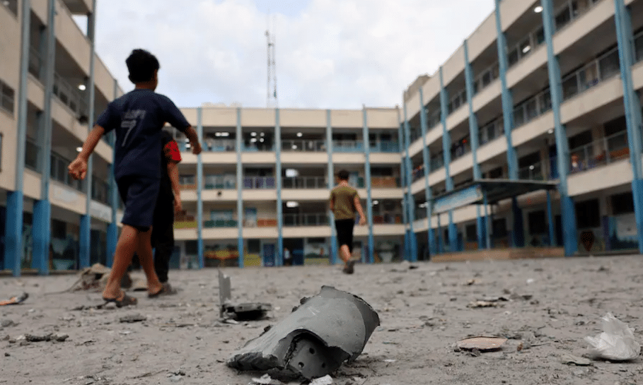 Palestinian children walk through the rubble of a school run by the United Nations shortly after an Israeli offensive on the night of 8 to 9 October 2023.