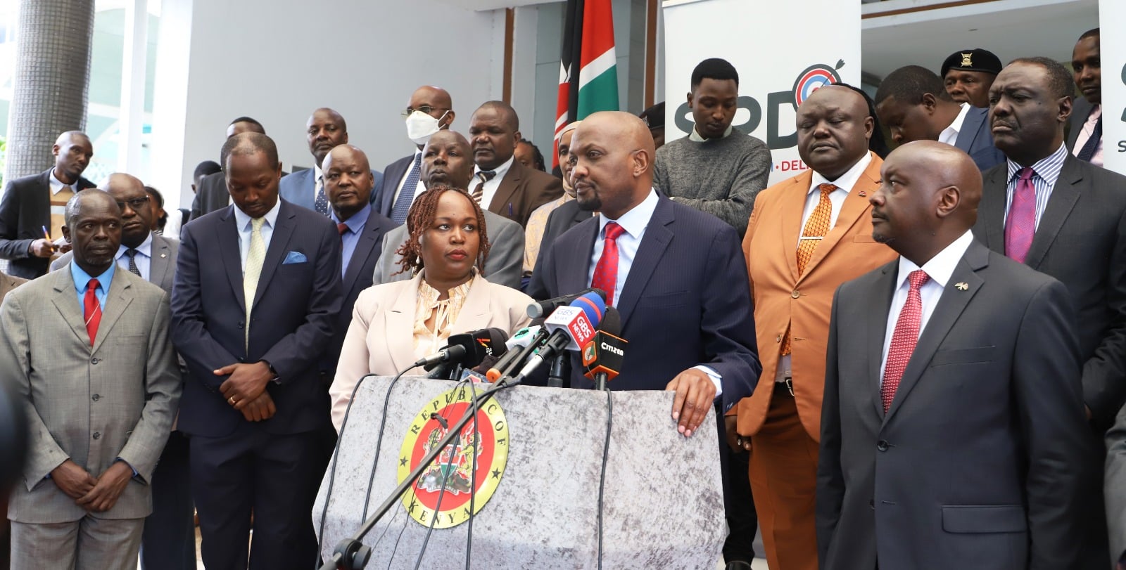 Trade Cabinet Secretary Moses Kuria (center) addresses a presser at the Ministry's headquarters.