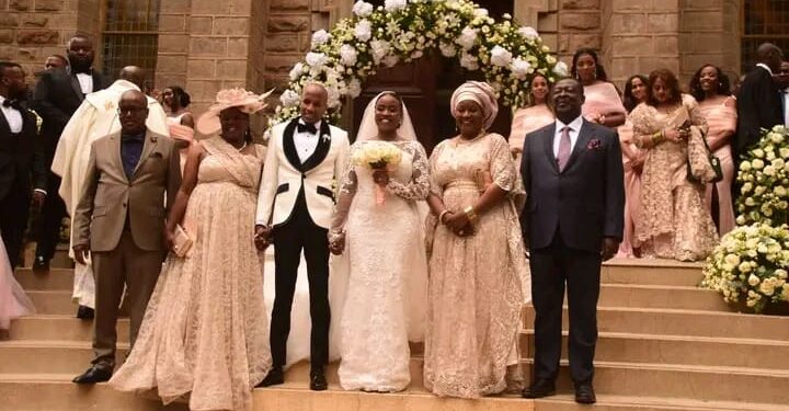 Prime Cabinet Secretary Musalia Mudavadi (right) and his spouse Tessie Mudavadi (next to him) pose for a photo during their daughter's wedding on October 28, 2023 in Nairobi.