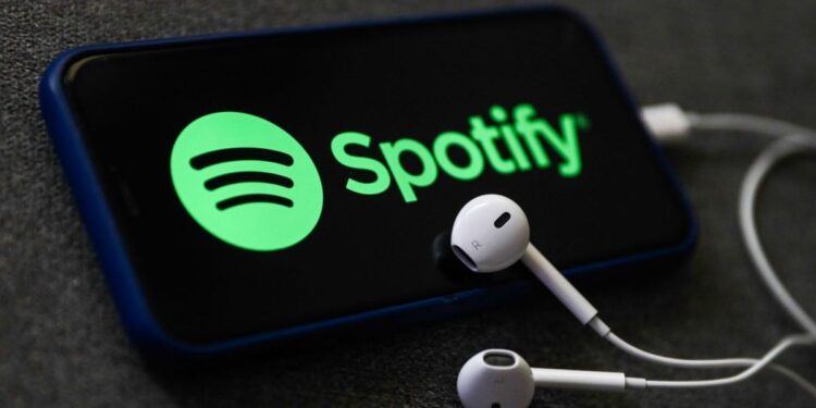 Spotify. A Spotify logo on phone and earphones.