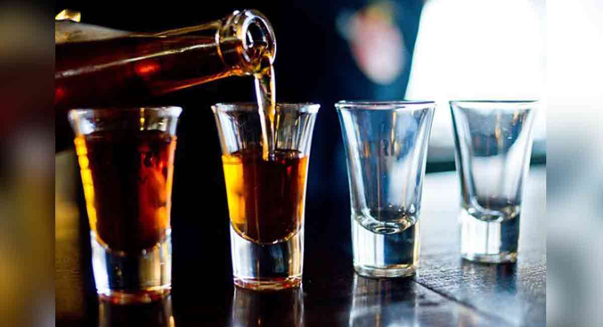 Alcohol being poured into glasses. Alcohol being poured into glasses.
