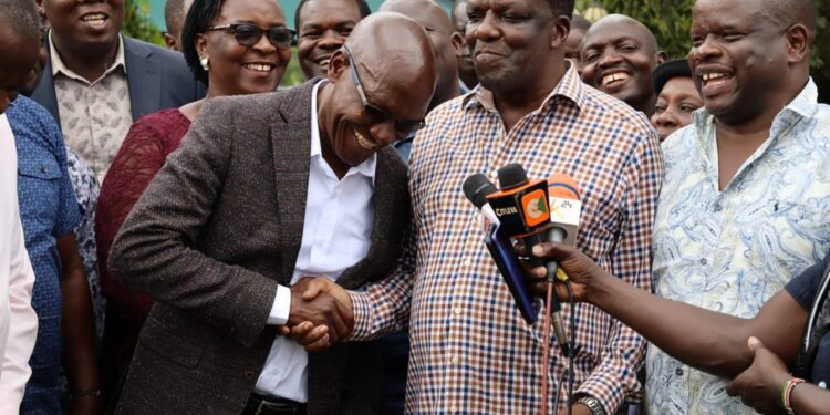 Former Kakamega Governor Wycliffe Oparanya shakes hands with Senator Boni Khalwale.