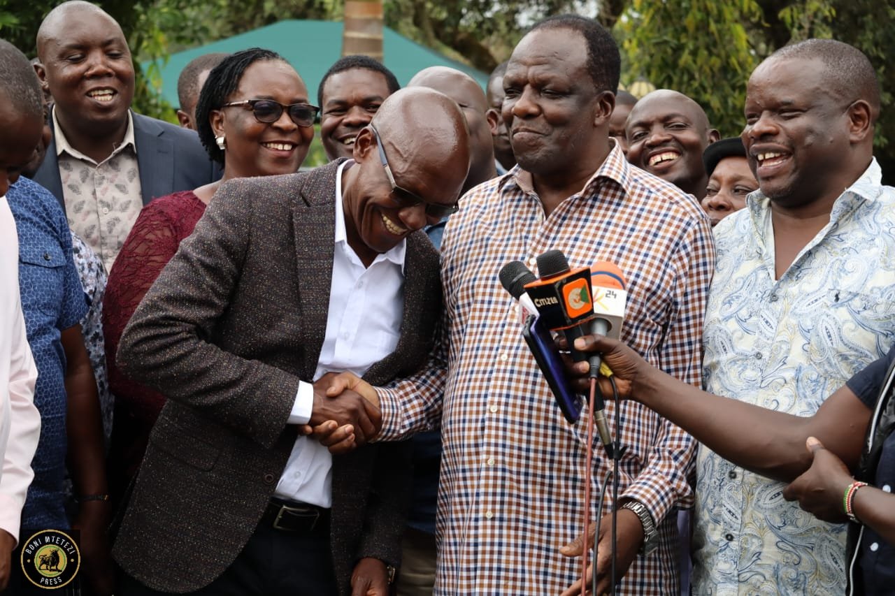 Former Kakamega Governor Wycliffe Oparanya shakes hands with Senator Boni Khalwale.