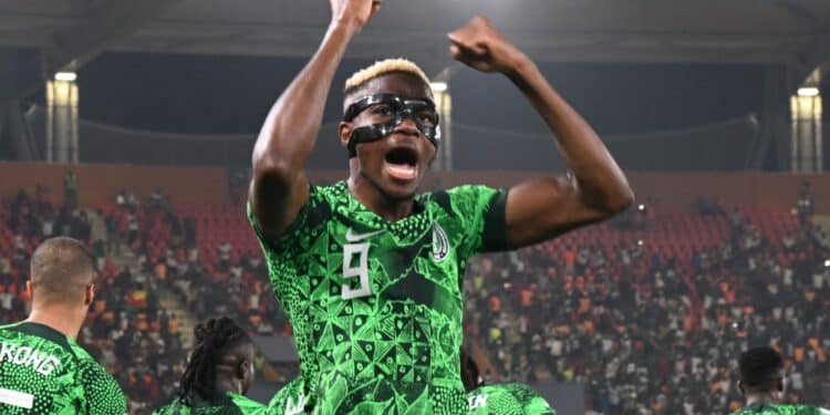 Nigeria Striker, Victor Osimhen wearing a face mask celebrating a 2-0 win against Cameroon.