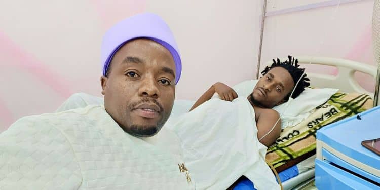 Musician Karangu Muraya poses for a photo with Peter Miracle Baby.