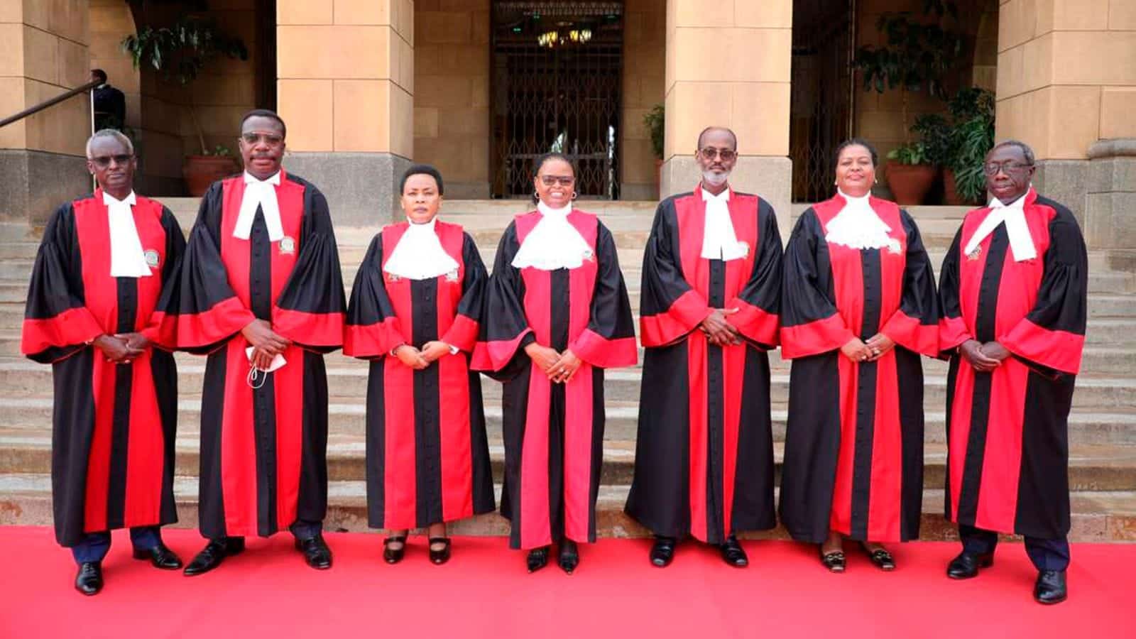 Supreme Court judges pose for a photo outside the SCOK.