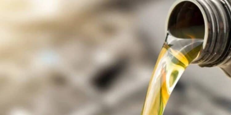 A photo of oil pouring from a can.