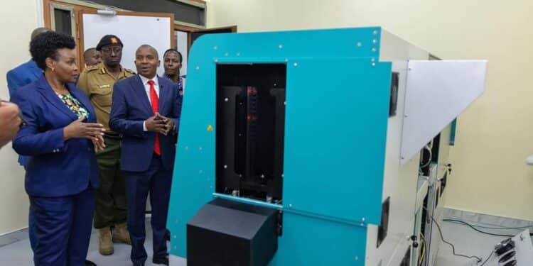 Interior CS Kithure Kindiki inspects a new passport printing machine.