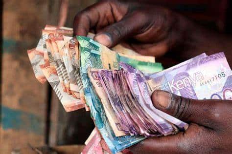 A photo of a pair of hands shuffling a bunch of money. PHOTO/BD