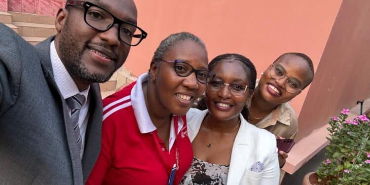 Officials pose for a photo after the release of Lydia Mbotela, a Kenya Airways staffer who detained in the DRC.