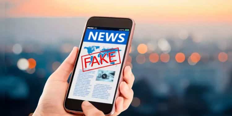 A stock photo of a phone screen displaying the fake news disclaimer.