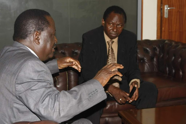 Opposition leader Raila Odinga and EX Magarini MP Harrison Garama Kombe. PHOTO/Courtesy