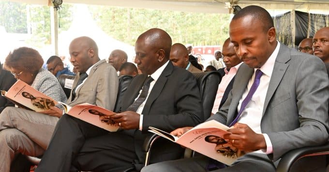 MP John Kiarie (R) sits next to President Ruto during the funeral ceremony of the MP's father. PHOTO/ Kiarie