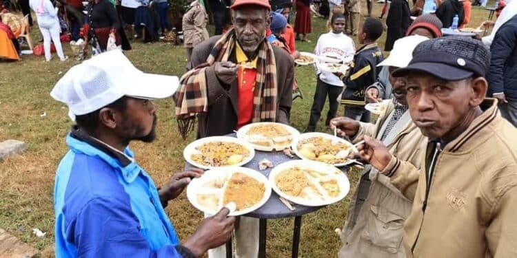 A past photo of residents in Mount Kenya enjoying 'Mchele Nyama' at the Sagana State Lodge.