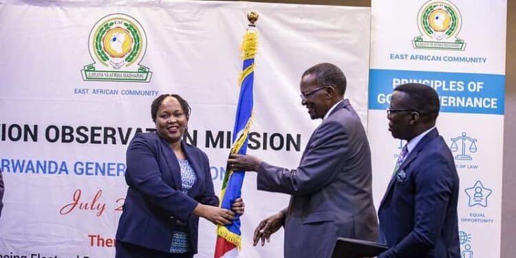 EAC Secretary General Veronica Nduva handing over EAC flag to former Chief Justice David Maraga, Friday, July 12. 