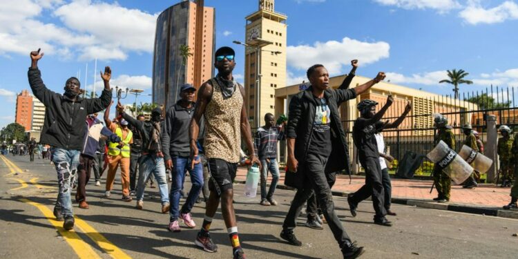 Kenyan police officers face off with anti-tax protesters outside the Kenyan parliament building in Nairobi on 25 June 2024. Photo by Gerald Anderson/Anadolu via Getty Images