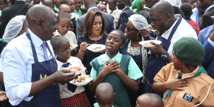 President William Ruto (left) and Nairobi Governor share a meal with school children during the launch of the Dishi na County program.