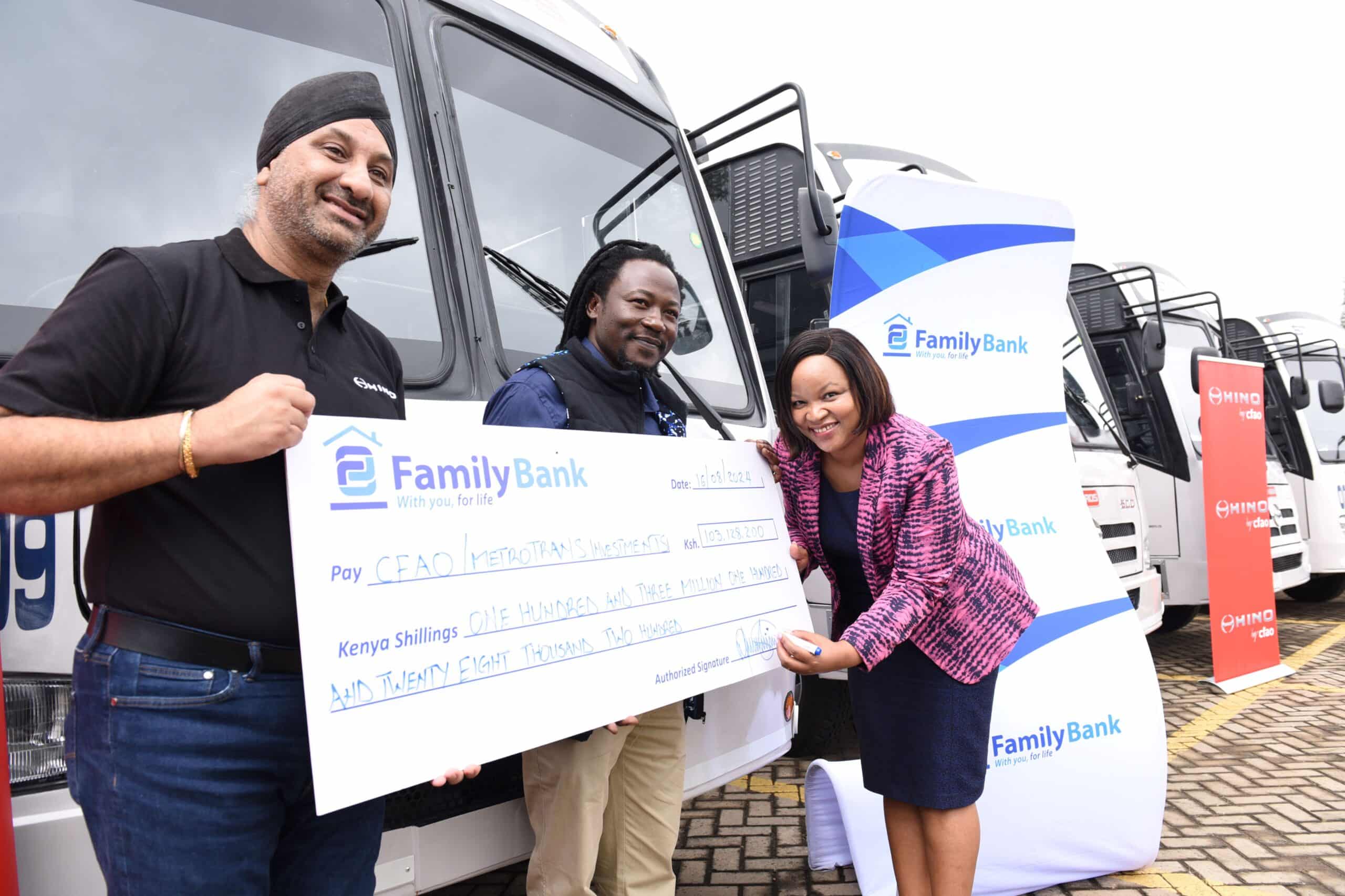 Family Bank CEO Nancy Njau signs a KES. 103 million cheque during the handover of 14 Hino buses financed by the Bank to CFAO Mobility Kenya Group MD Arvinder Reel & Metro Trans Investment Limited Chairman Oscar Omurwa.