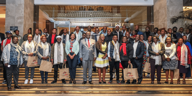 Prime CS Musalia Mudavadi poses with a group of 64 teachers who secured placements in the US on July 30, 2024.