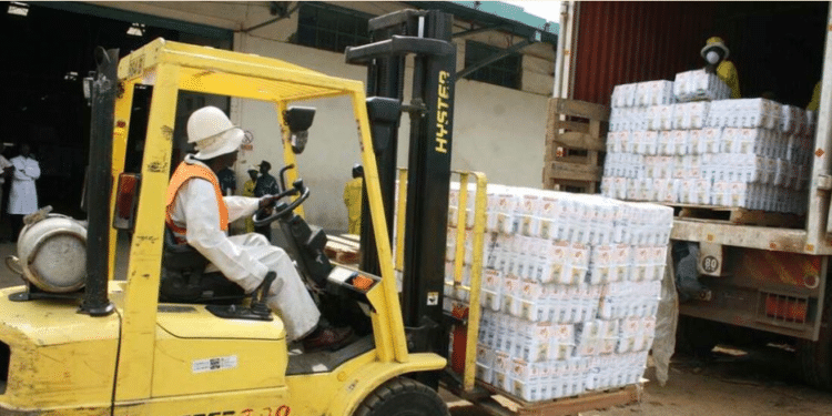 Workers load flour on to a truck for dispatch at Unga Limited plant in Eldoret. FILE PHOTO | NMG