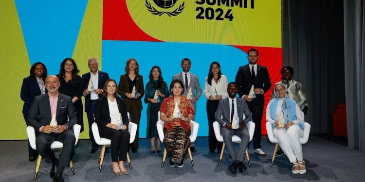 Kenya’s Kevin Getobai (seated, second from right) receives the 2024 SDG Pioneers award in the Africa SMEs Category at the Leaders Summit during the UN General Assembly in New York. Standing far left is UN Global Compact Executive Director, Sanda Ojiambo.