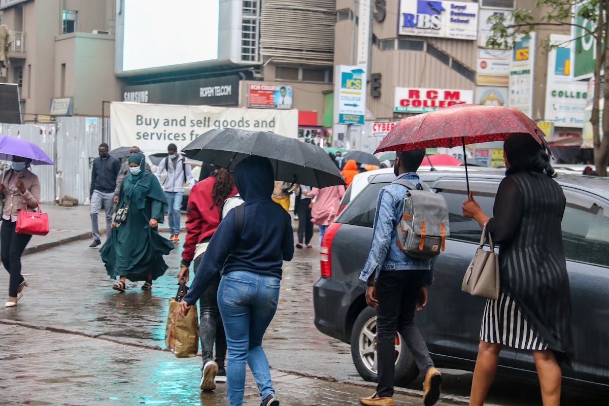 weather, Nairobi City dwellers use umbrellas to take cover from the rainfall. PHOTO/ WILFRED NYANGARESI. Kenya Met. Kenya Met