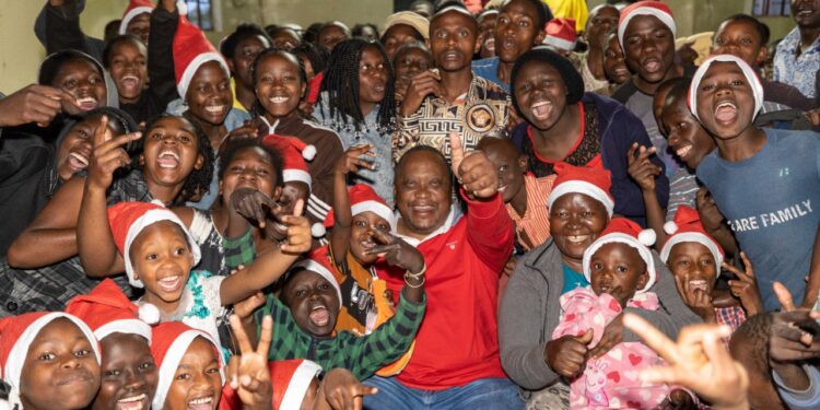 Former Kenya's President Uhuru Kenyatta hosting children in December 2022. PHOTO/State House.