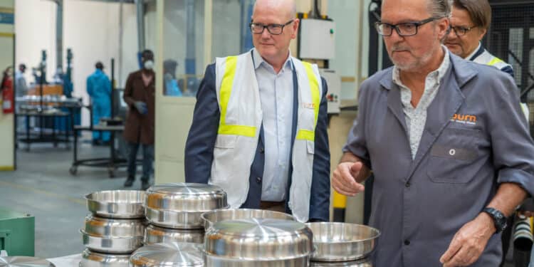 BURN- EIB VP Ostros looking at some of the products manufactured at factory