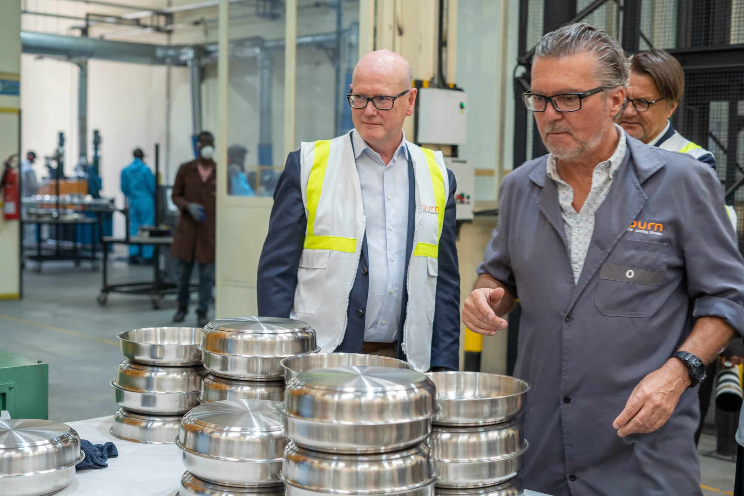 BURN- EIB VP Ostros looking at some of the products manufactured at factory