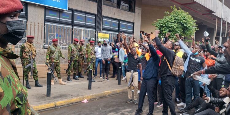 Protestors face police officers in Nairobi CBD on June 20, 2024. PHOTO/Edwin Hinda. Canada