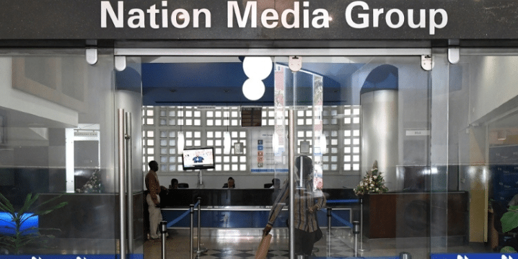 People walk at the entrance to the headquarters of Nation Media Group on Nairobi on January 19, 2018. PHOTO/Simon Maina,AFP.