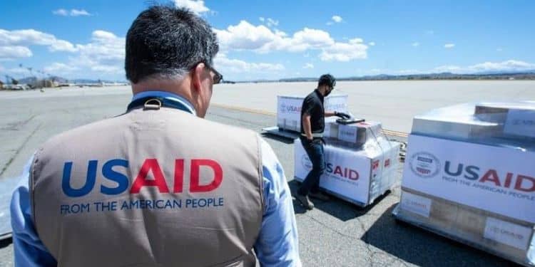 USAID humanitarian officers distributing relief items.