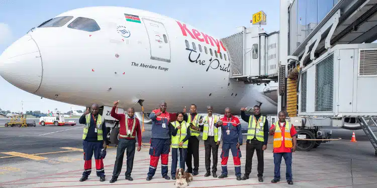 Kenya Airways staff posing in front of a passenger Boeing at JKIA. PHOTO/KQ