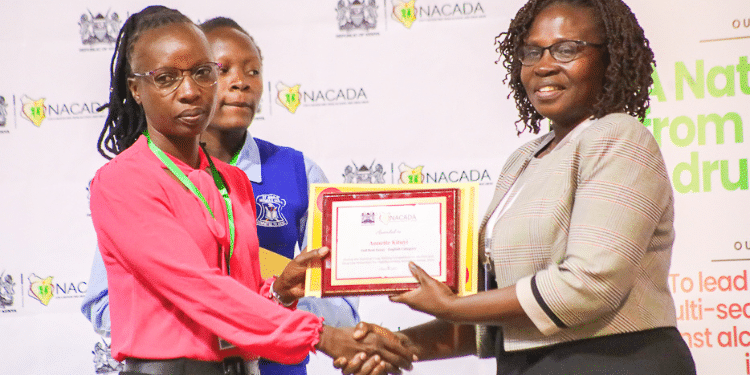 A teacher being awarded at NACADA Essay competition. PHOTO/NACADA X