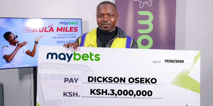 Dickson Oseko holding a cheque of Ksh3 million from Maybets. PHOTO/Maybets.