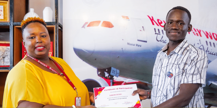 Simeon Nyakundi receiving won top recognition with Kenya Airways PHOTO/ TUK