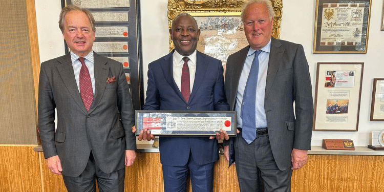 Equity Bank CEO James Mwangi (Centre) displays the award. Photo/ Handout