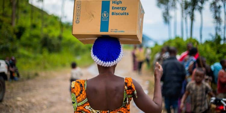 A woman carries a box of WFP relief products