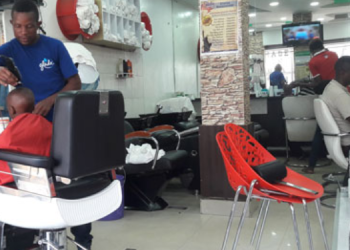 A barber working at States Barber Suite in Umoja Innercore estate, Nairobi. PHOTO/Nairobi News. PAVRISK