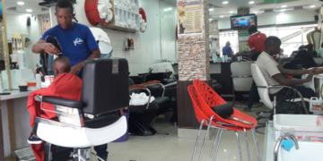 A barber working at States Barber Suite in Umoja Innercore estate, Nairobi. PHOTO/Nairobi News. PAVRISK