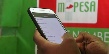 A Customer Using The Safaricom Money Transfer Mobile App. Photo/Bd