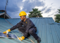 A Man Installing Solar Panel On A Roof Photo/Sun King