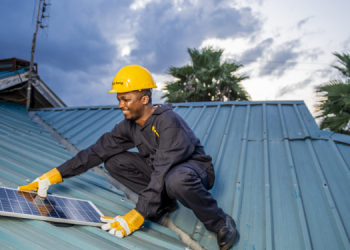 A Man Installing Solar Panel On A Roof Photo/Sun King
