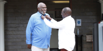 President WIlliam Ruto makes the collar of East African Court of Justice judge Charles Nyachae. Photo/DPP