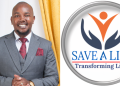 Founder And President Of Save A Life Community Dr. Joseph Murimi With The Community’s Logo. Photo/Save A Life Community.