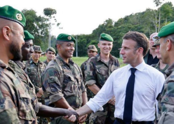French President Emmanuel Macron meets with members of the 3rd Foreign Infantry Regiment of the French Foreign Legion at the Advanced Operational Base in Camopi, as part of a two-day visit to the French overseas department of Guiana, South America, on March 25.