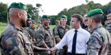 French President Emmanuel Macron meets with members of the 3rd Foreign Infantry Regiment of the French Foreign Legion at the Advanced Operational Base in Camopi, as part of a two-day visit to the French overseas department of Guiana, South America, on March 25.