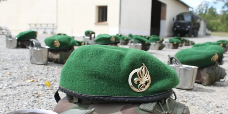 Green berets belonging to recruits of the French Foreign Legion placed on the ground during a training break at a recruitment center in France
