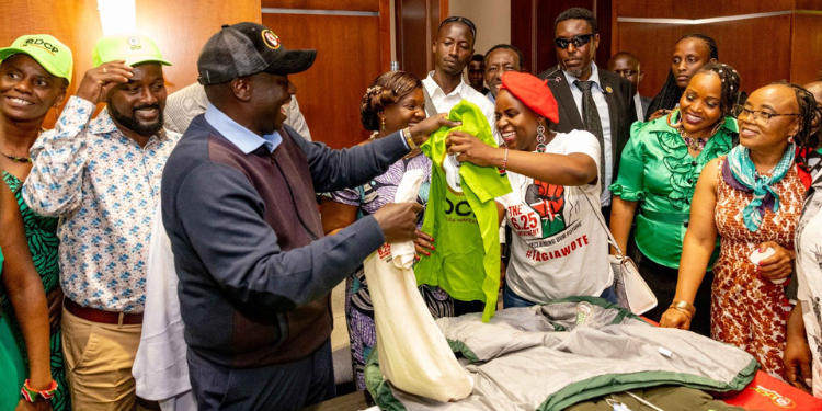 Former Deputy President (Dp) Rigathi Gachagua Hands A Over Dcp-Party T-Shirt To Valentine Wanjiru Githae After A Community Public Rally In Baltimore, Maryland On July 27, 2025. Photo/Gachagua X.