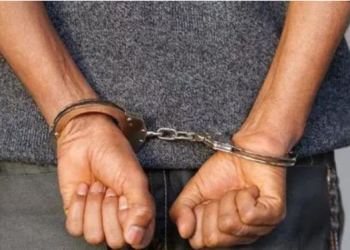 A Suspect Arrested And Put In Handcuffs. Photo/Nation.